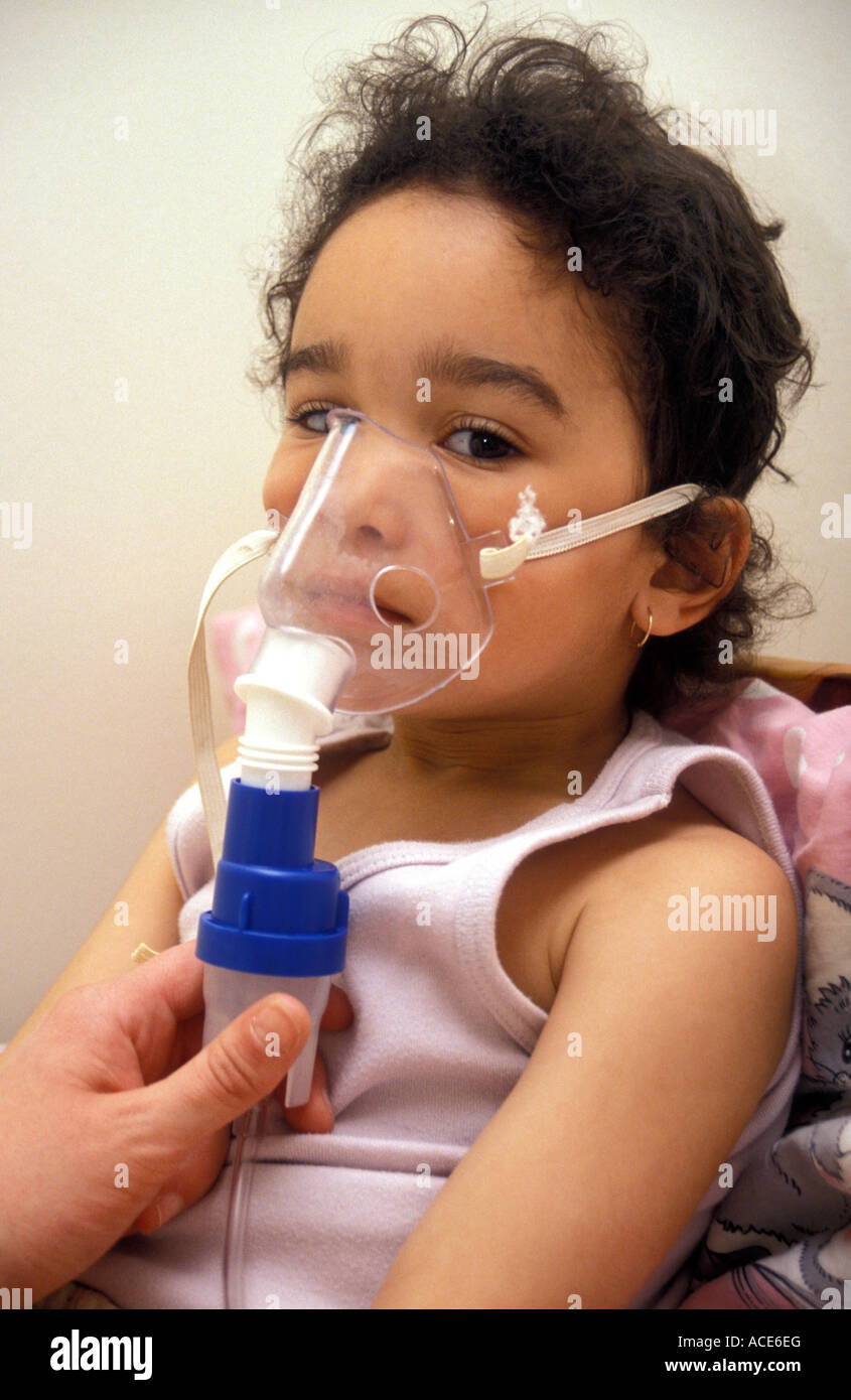 mixed race girl aged around 5 being administered salbutamol for asthma  through nebuliser Stock Photo - Alamy