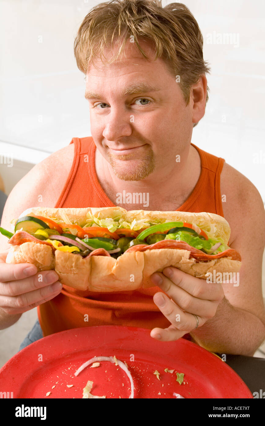 Happy guy holding sandwich looking hi-res stock photography and images ...