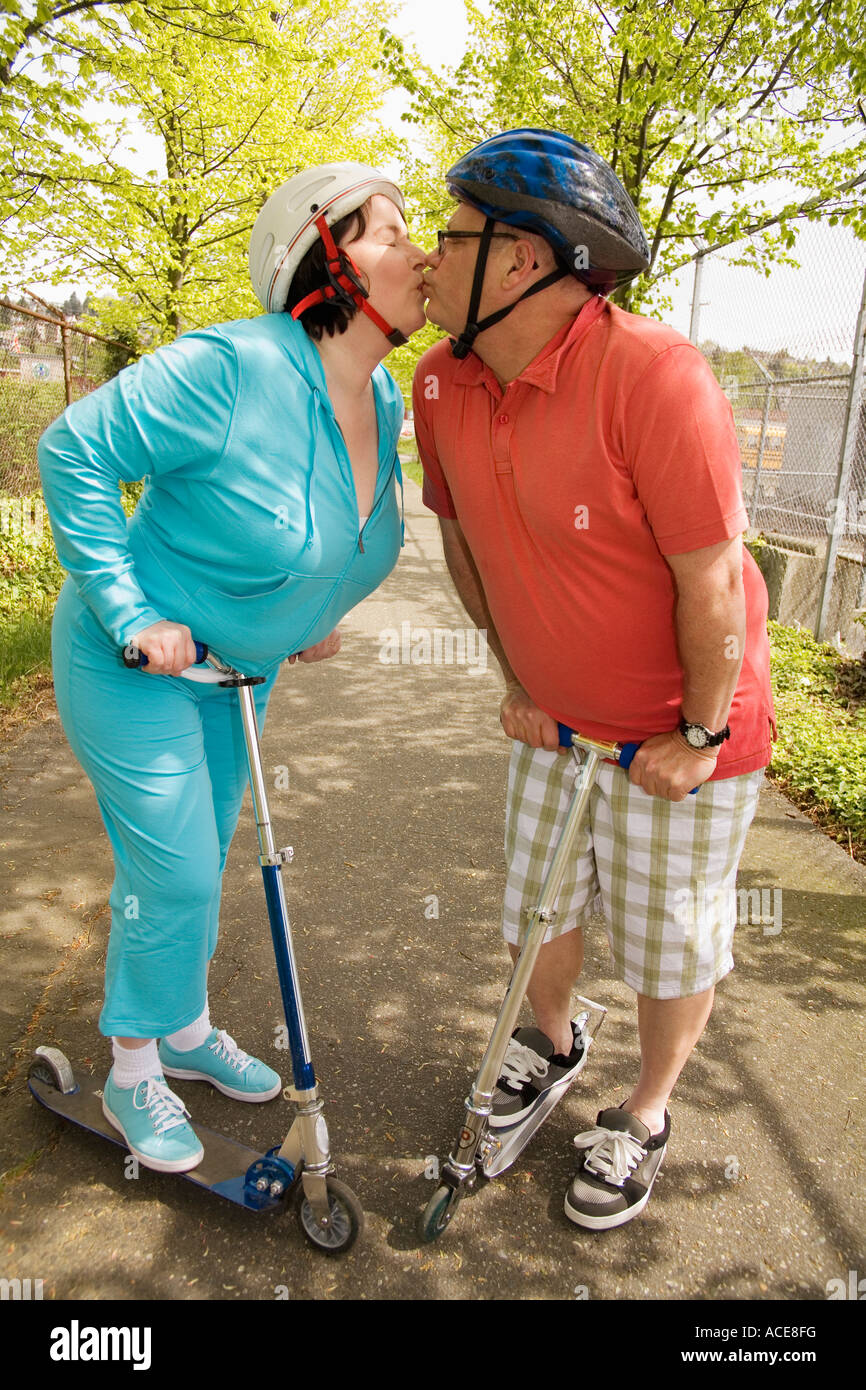 Couple riding scooters Stock Photo