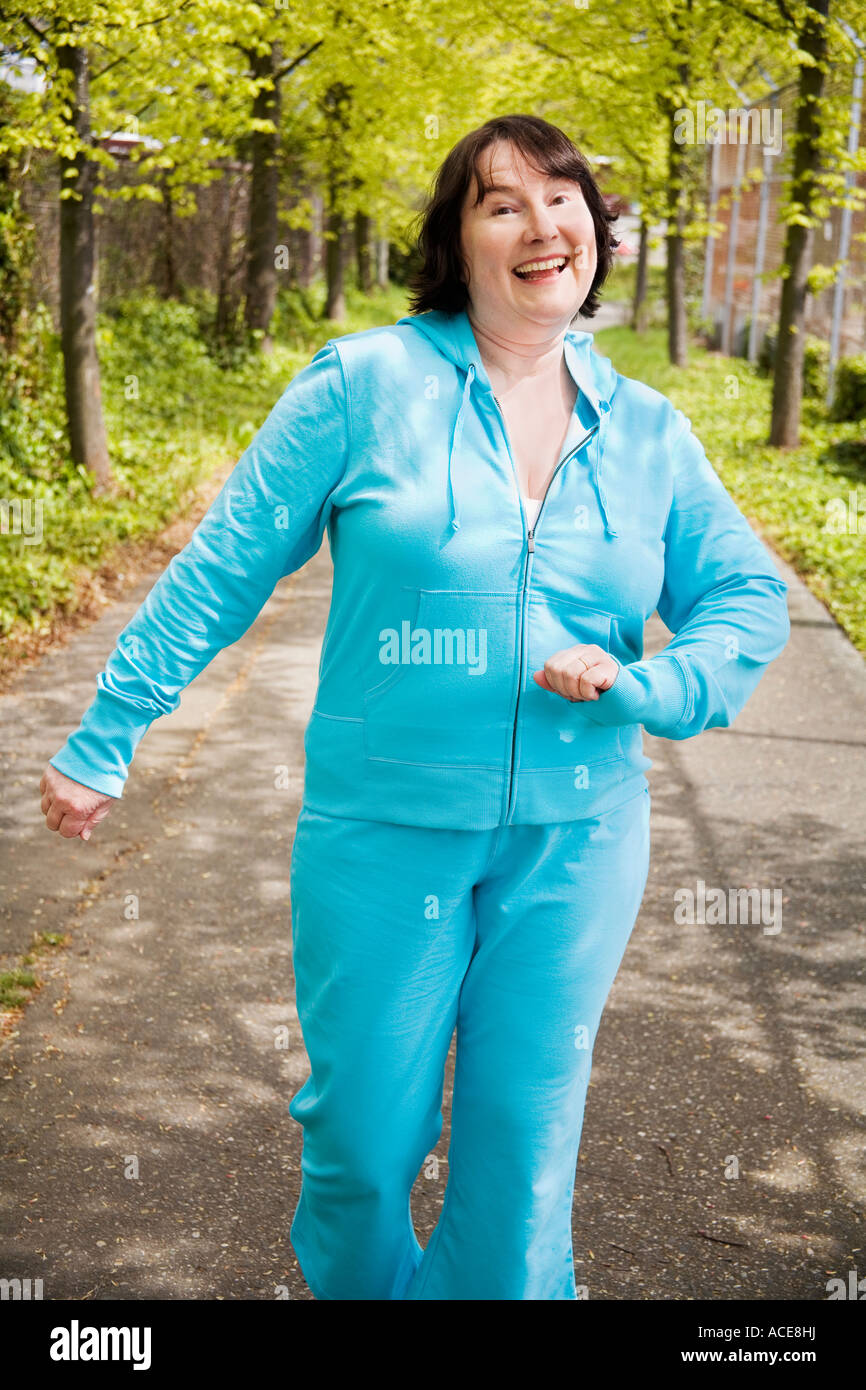 Woman power walking outdoors Stock Photo