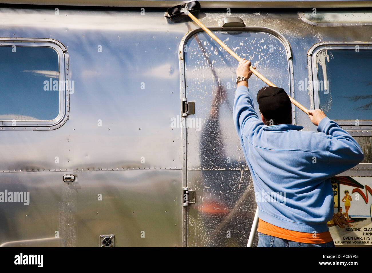 Man scrubbing recreational vehicle Stock Photo