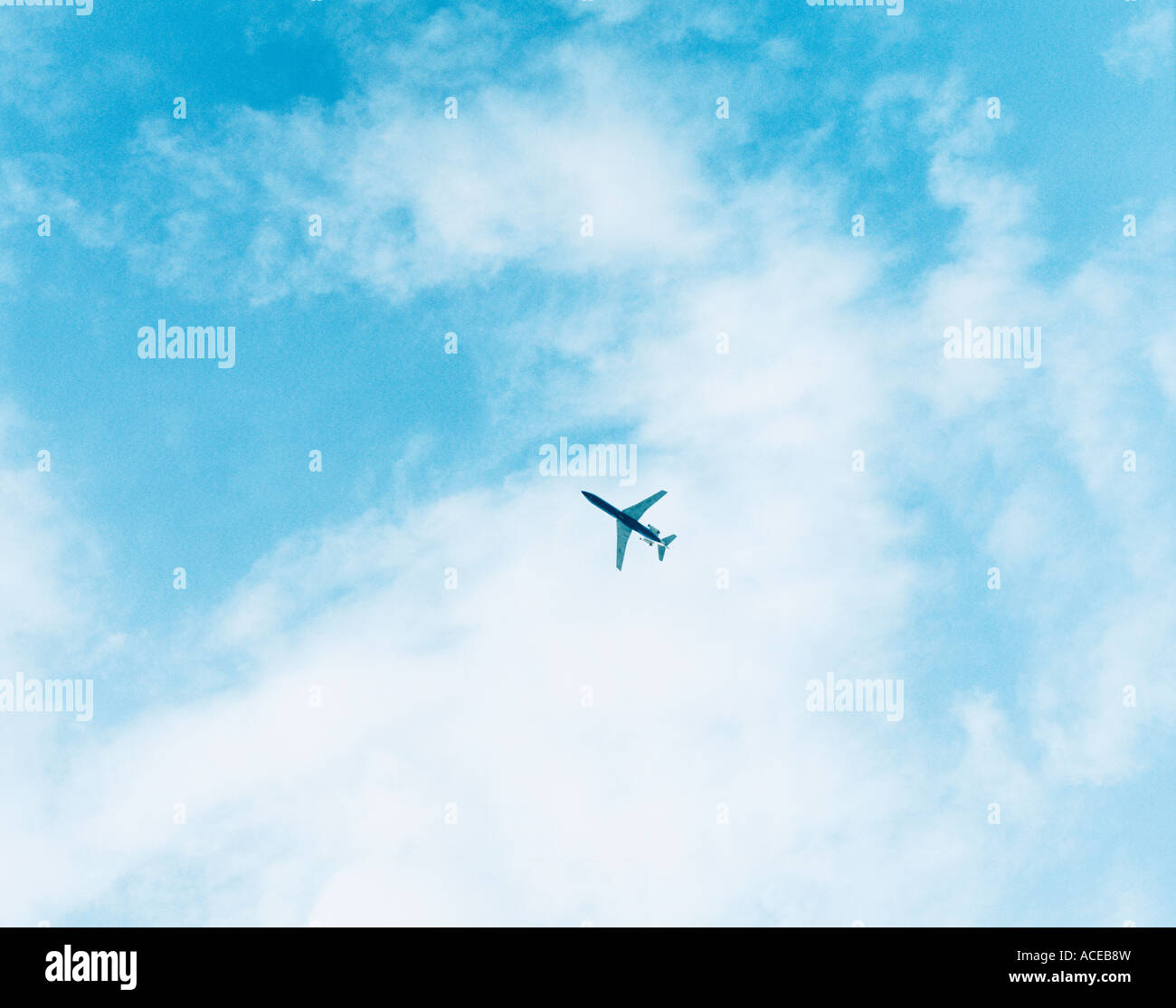 An airplane on a cloudy sky Stock Photo - Alamy