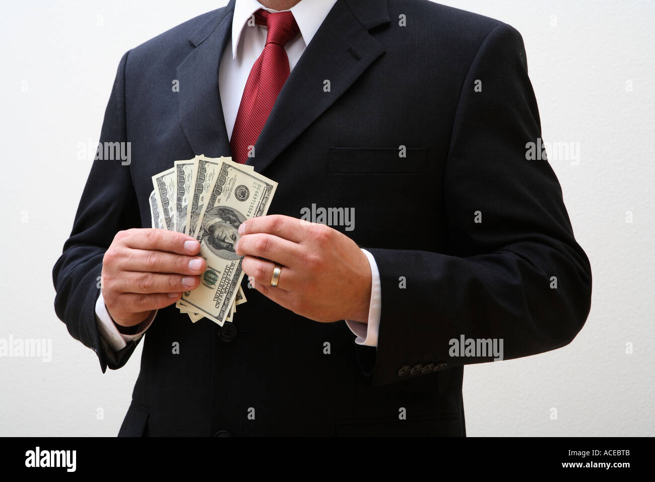 Businessman holding 100 dollar bills Stock Photo