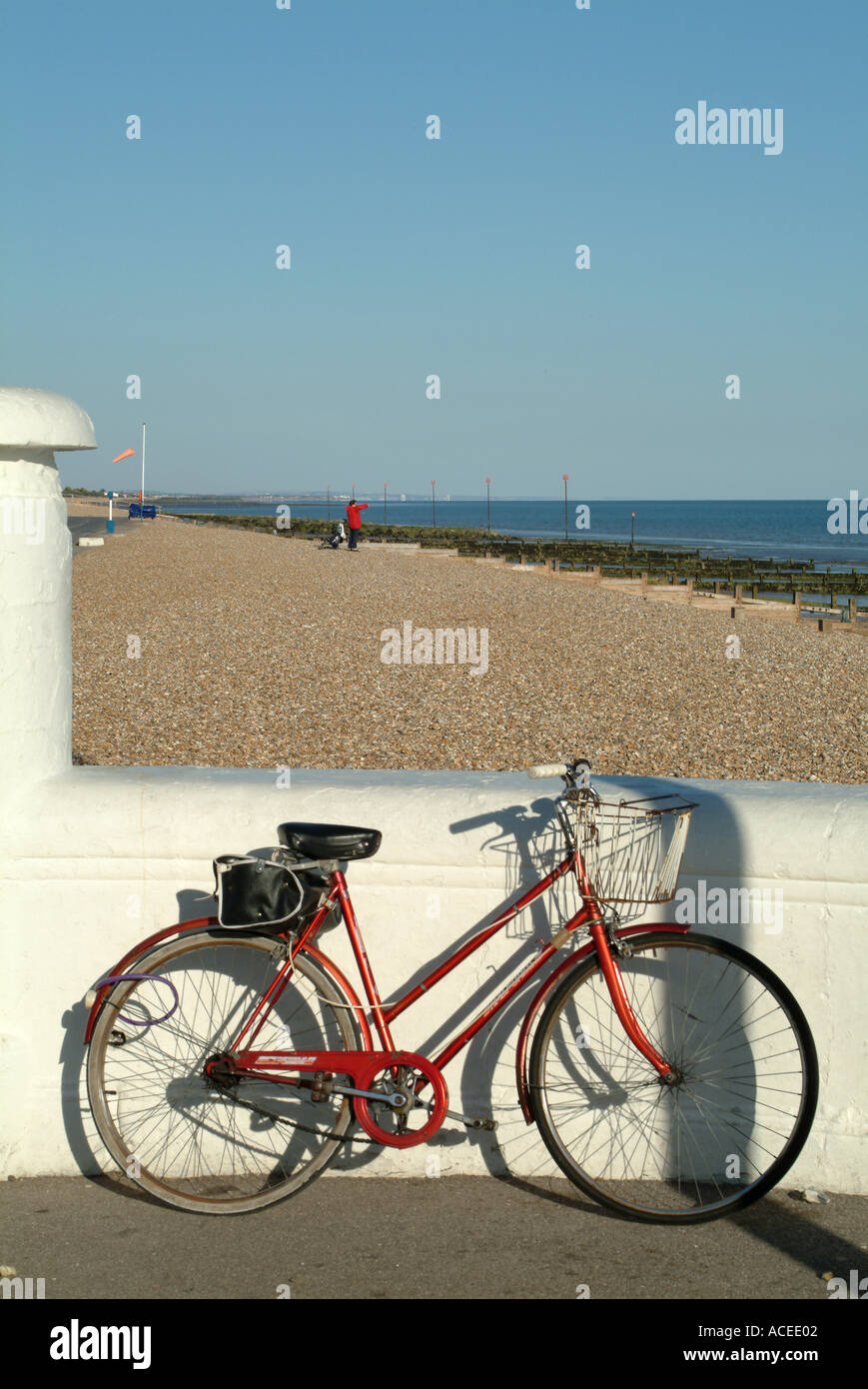 Ladies Red Bicycle Leaning Against White Wall at Bognor Regis West