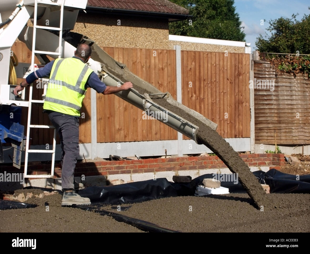 Ready mixed concrete delivery driver moving chute direction whilst