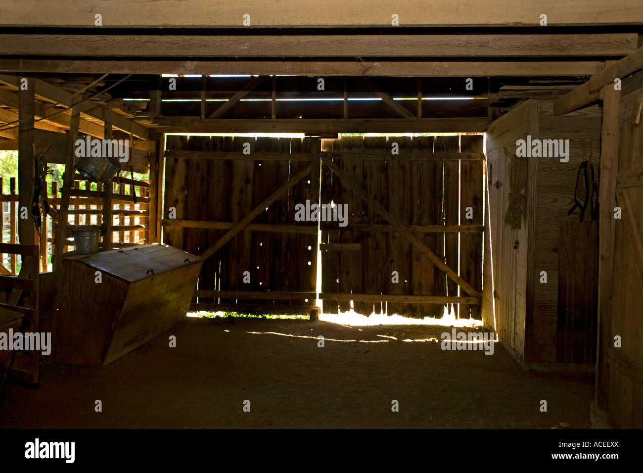 Barn inside to closed doors implements and tools Stock Photo Alamy