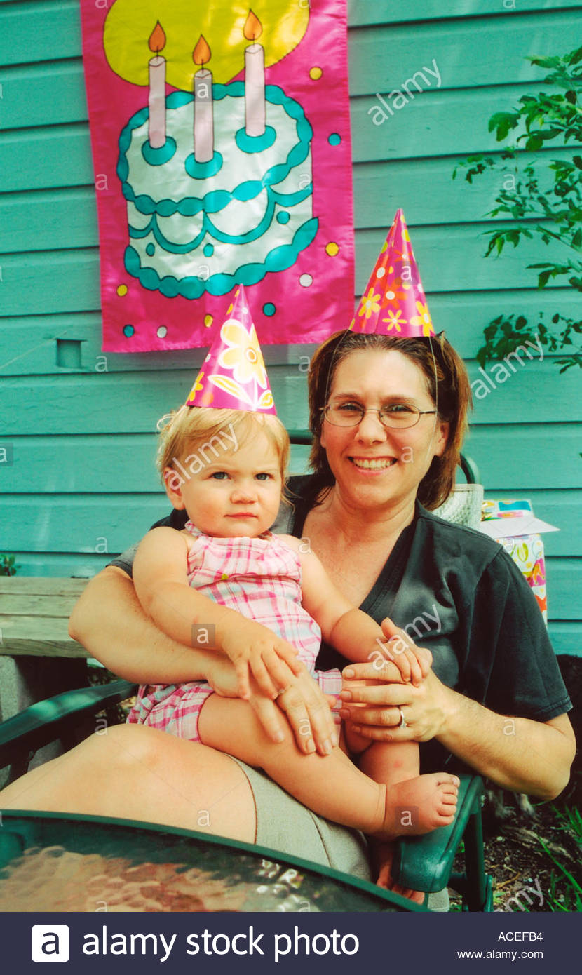 Baby S First Birthday Party Baby Aunt Wearing Party Hats Uk Stock