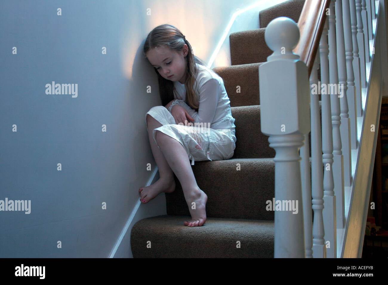 sad and lonely child on the stairs Stock Photo - Alamy
