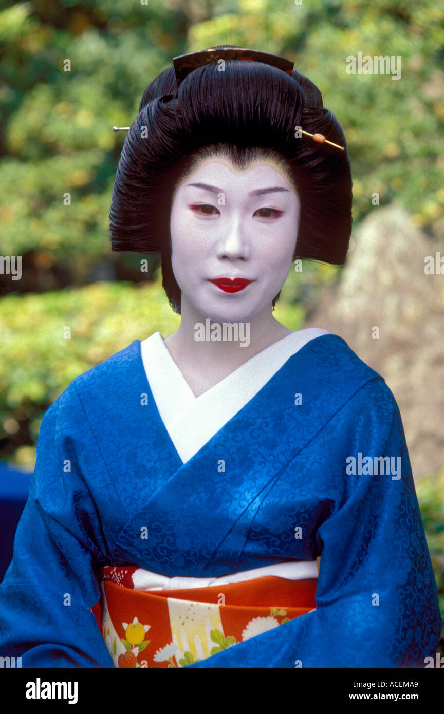 Geisha, or geiko, girl posing for a photo in a garden in Kyoto Stock Photo
