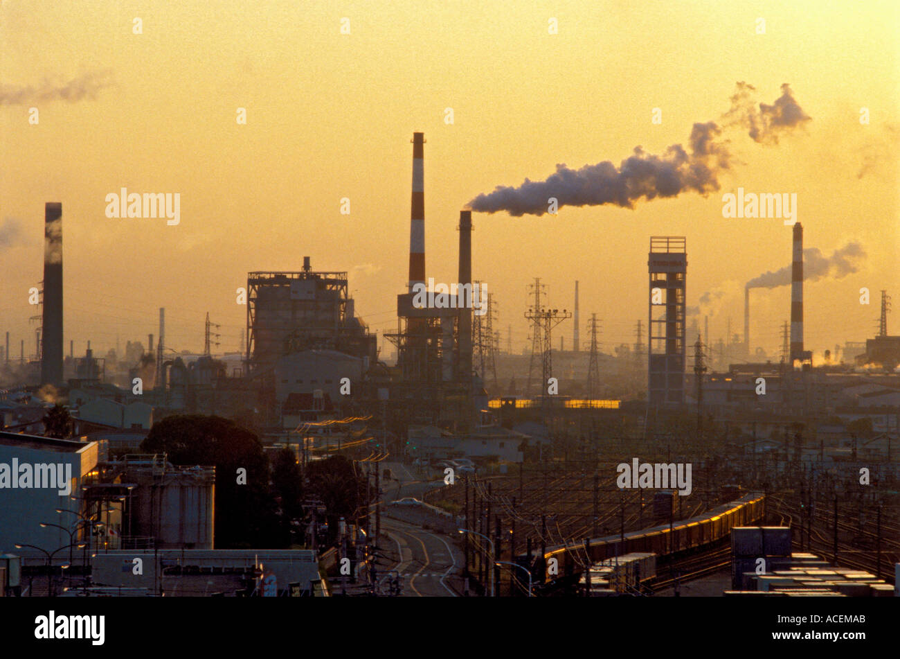 Smoke billows from factory chimneys at sunset in the Fuji City area of Shizuoka Prefecture, Japan's industrial complex Stock Photo