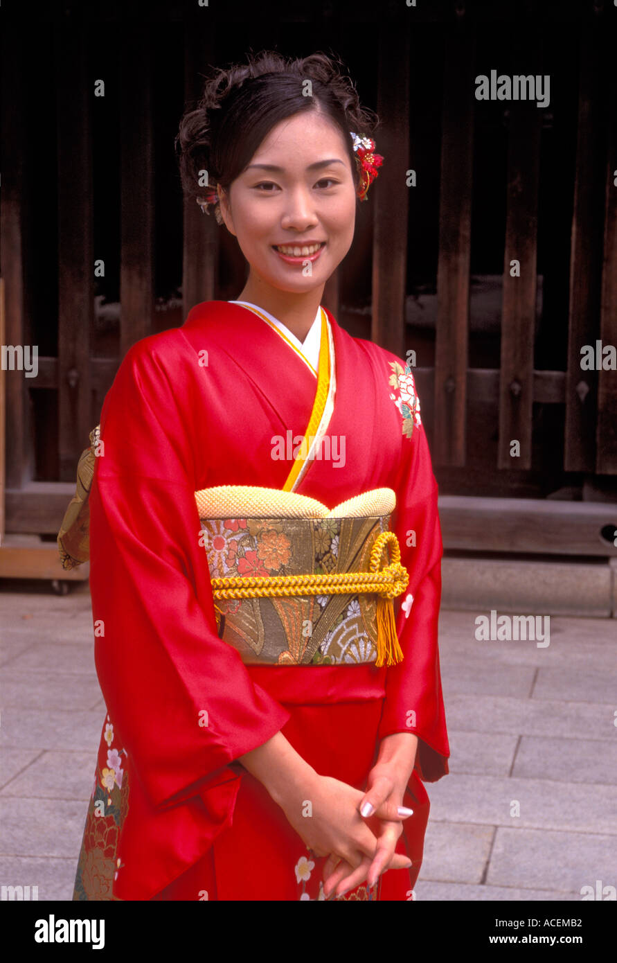 Young woman posing for photo wearing her finest red silk kimono Stock Photo