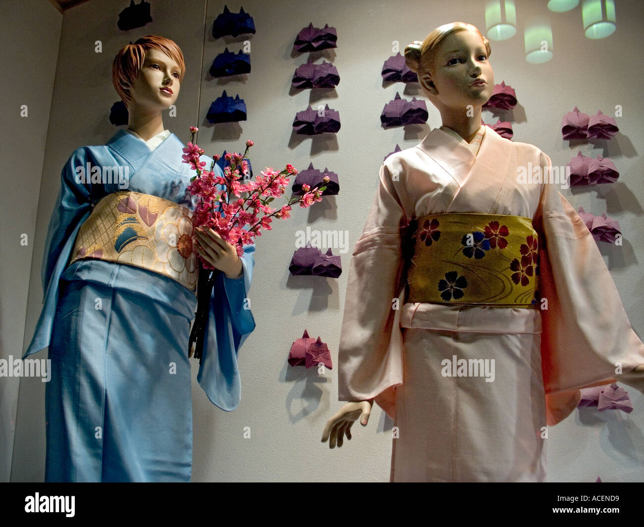 Two mannequins in a department store show window wear the latest Stock