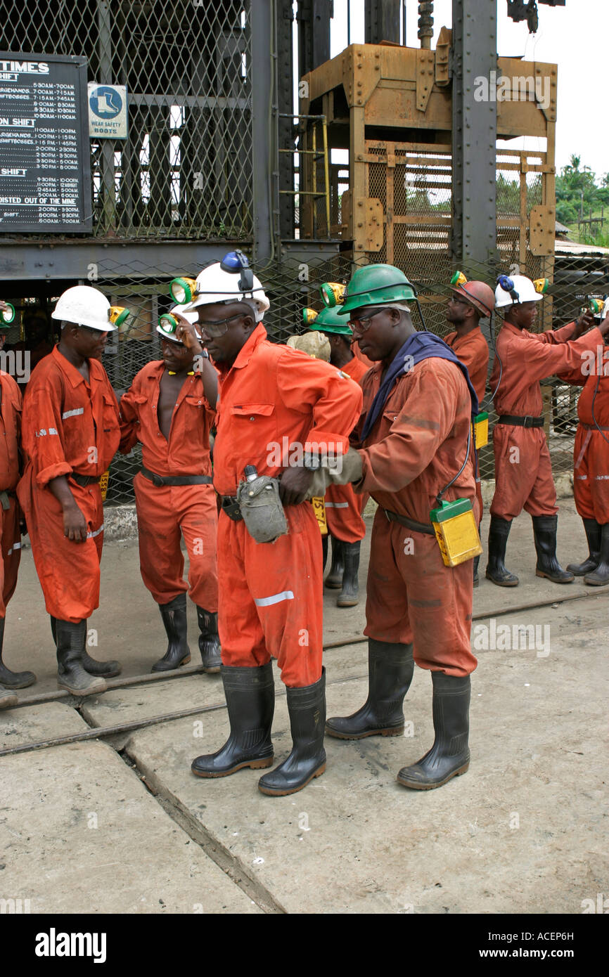 Gold miners doing a health and safety check on colleagues mining equipment before next shift underground, Ghana Stock Photo
