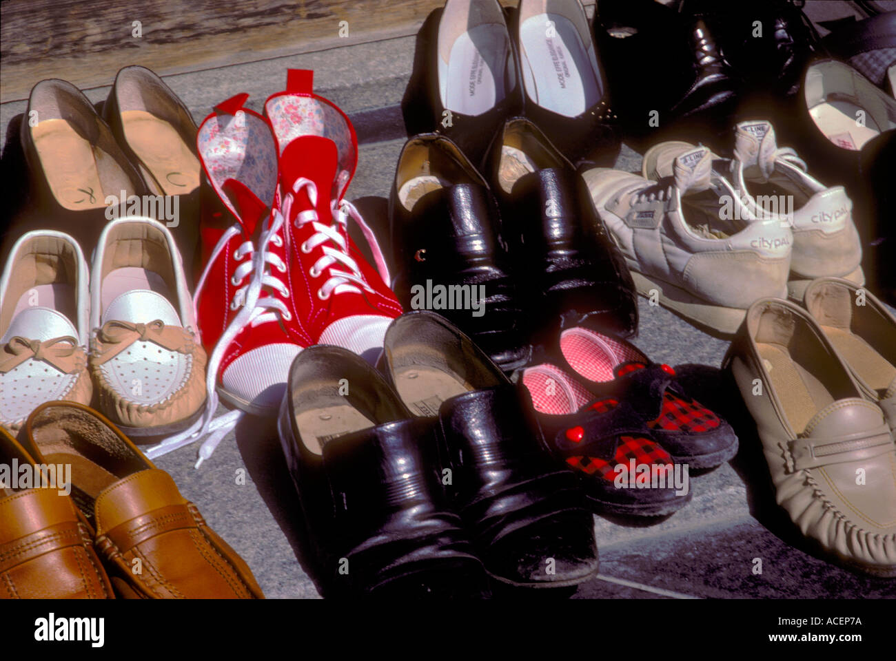 Collection of shoes at bottom of step removed before entering a temple in Japan Stock Photo