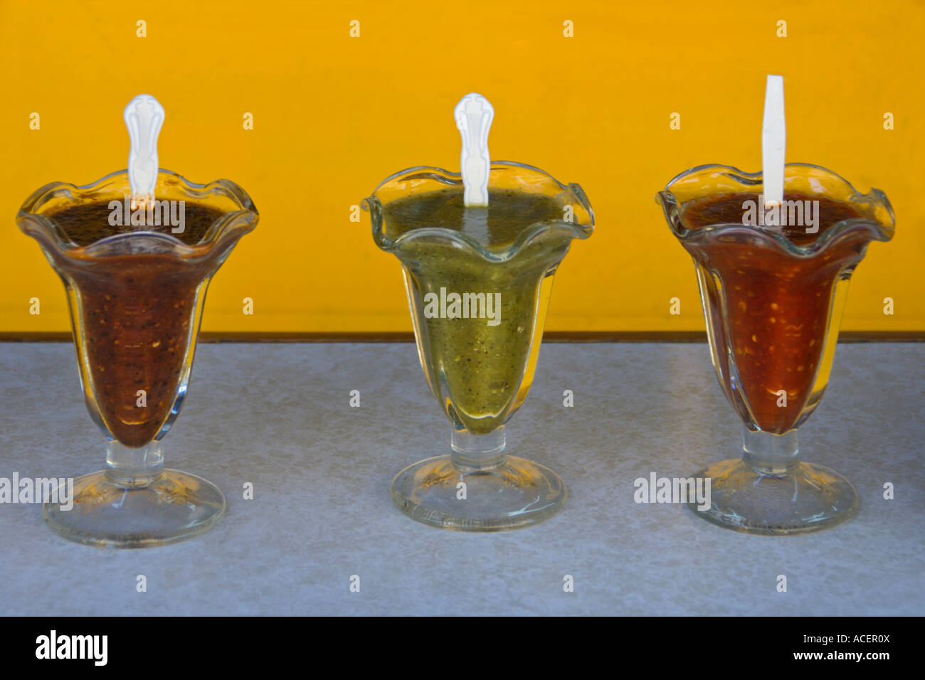A variety of salsas await diners eating fish tacos in Ensenada, Baja California, Mexico. Stock Photo