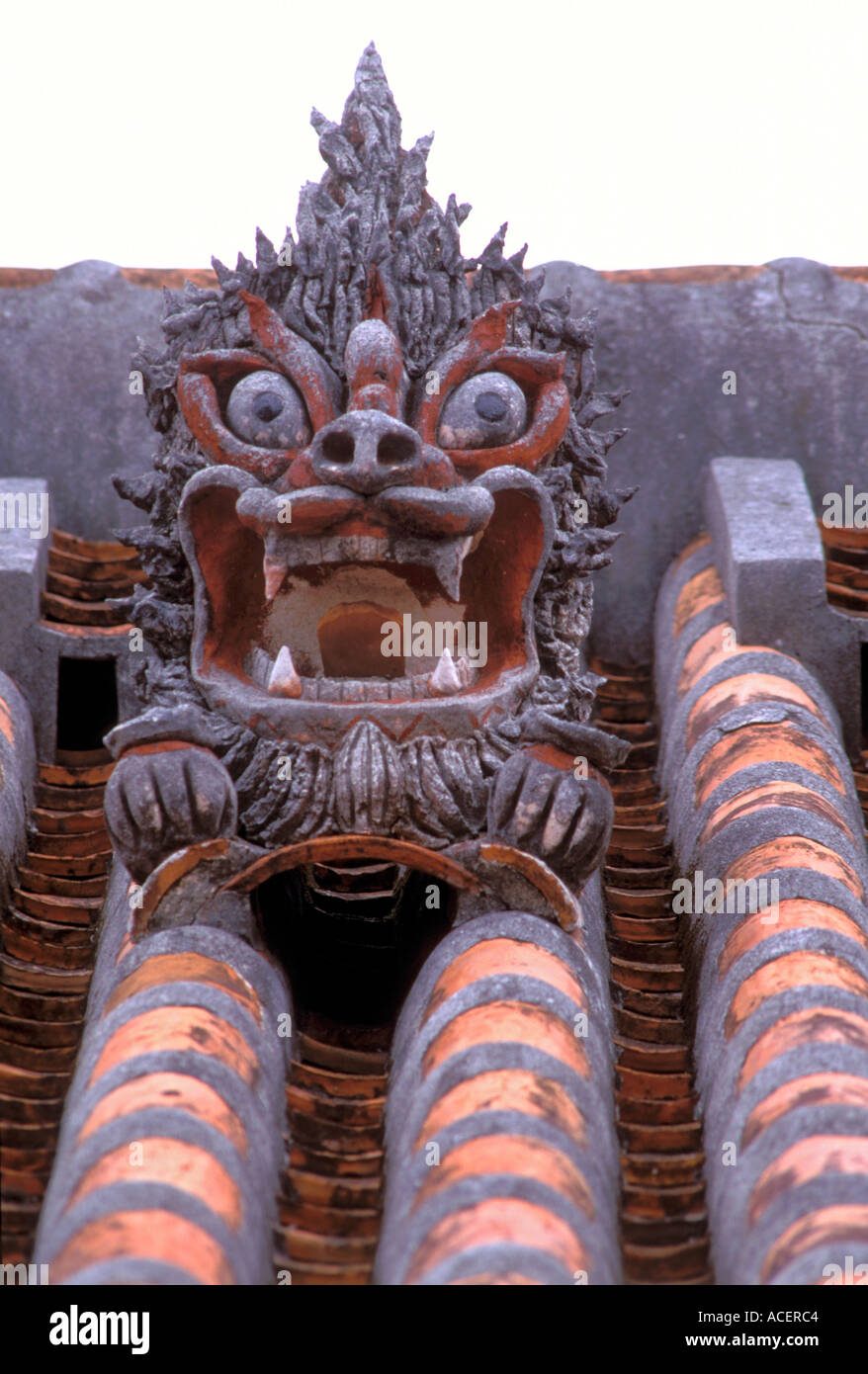 Scary Shisa lion head on roof of traditional Okinawan residence to keep evil spirits at bay Stock Photo