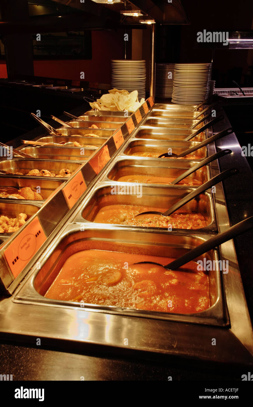 Serving trays of curry at an Indian Restaurant, UK Stock Photo