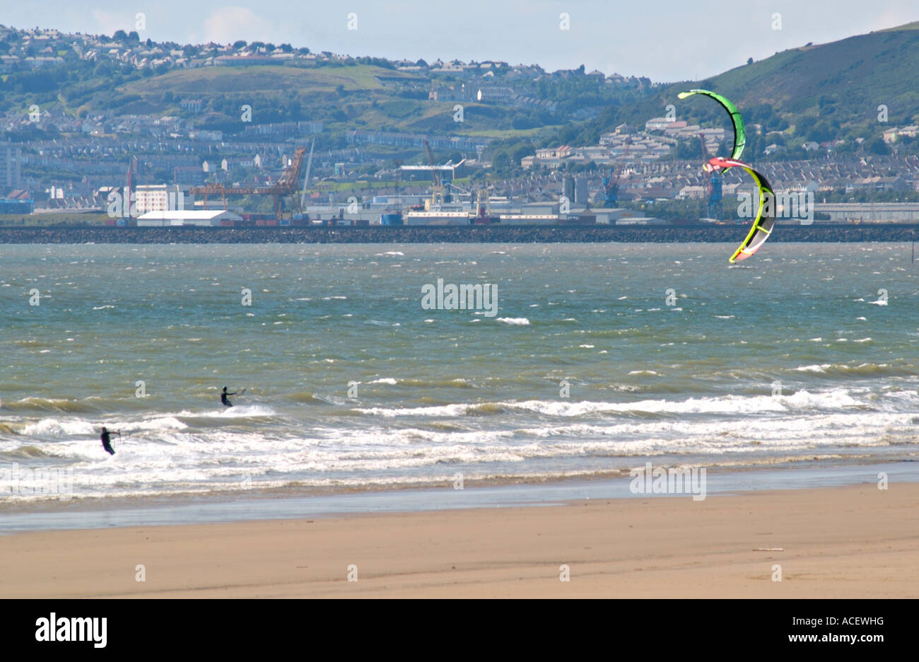 Kite surfers off Aberavon beach with Swansea in the distance Wales UK Stock Photo