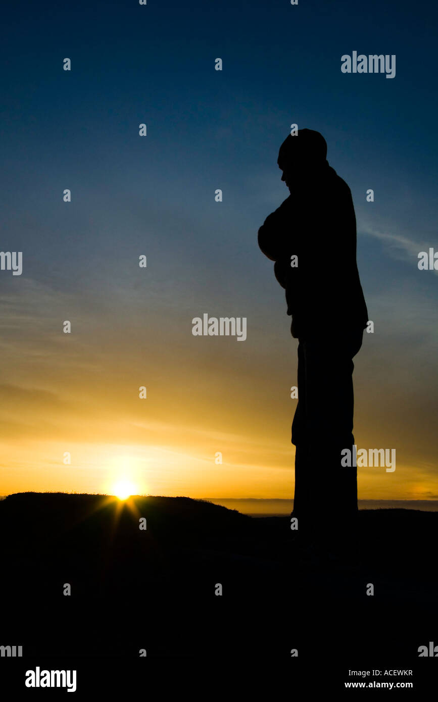 20 Something male watching sunset over ocean, north end of Lost Coast Wilderness Trail, Mattole Beach Campground, California. Stock Photo