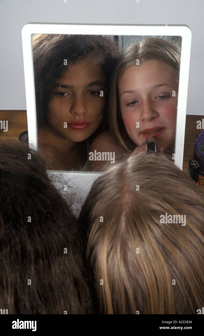 young girls looking at themselves in the mirror Stock Photo