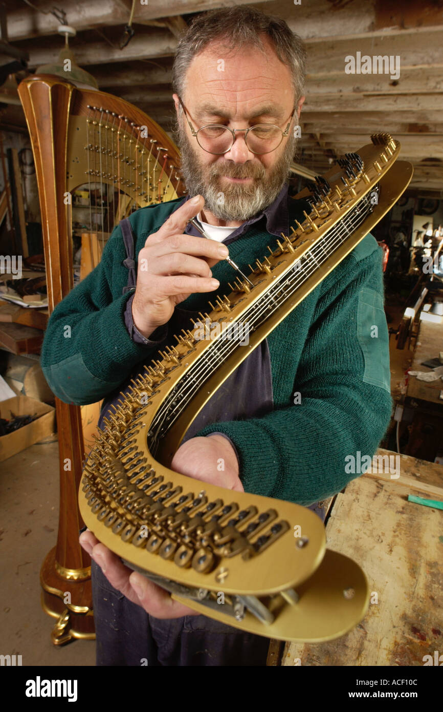 Allan Shiers harpmaker of Capel Dewi Llandysul Ceredigion adjusting the harmonic curve of a pedal harp Stock Photo