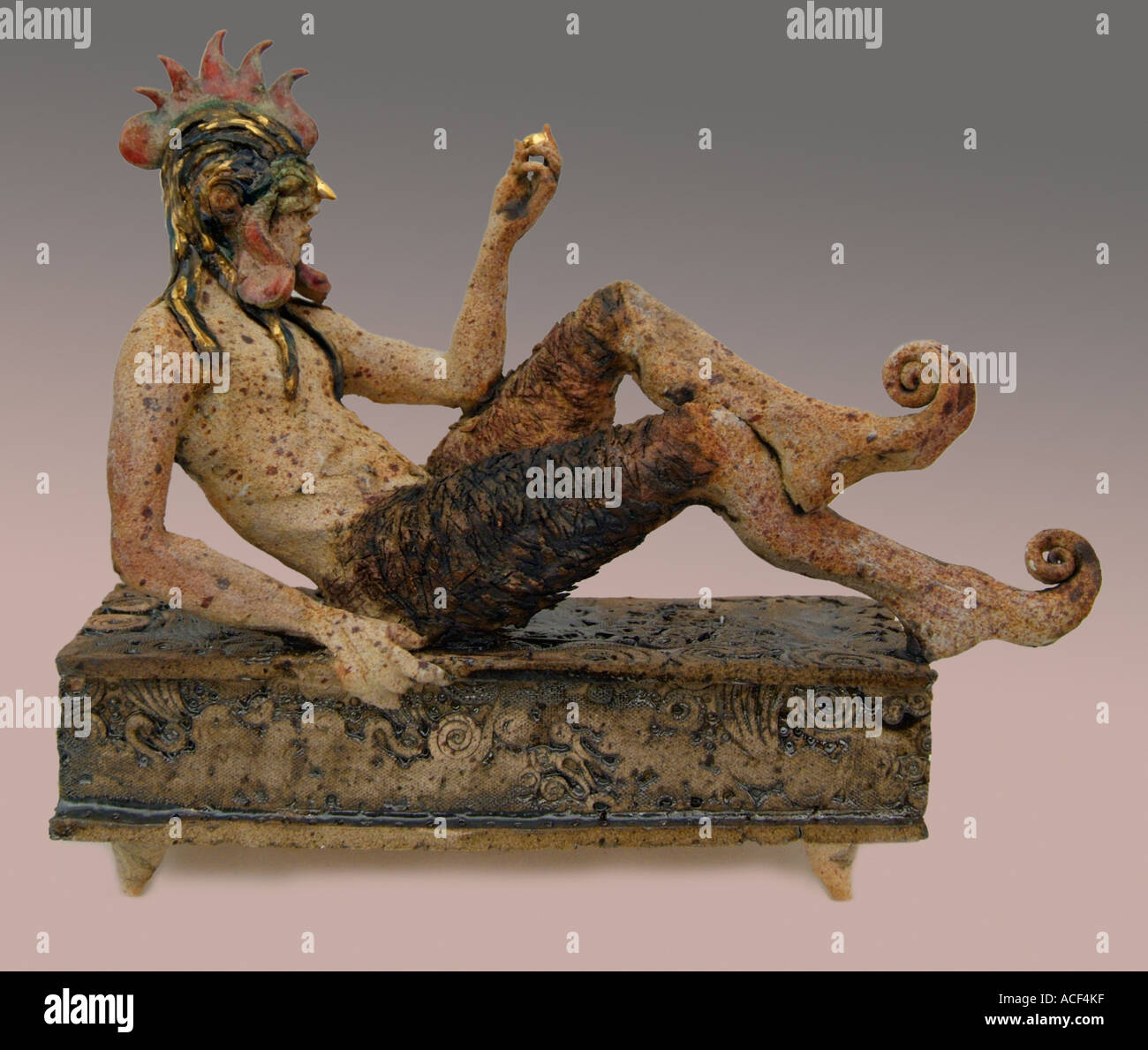 pan figure mythical figure seated on box Close up resting half human goat Greek mythology fantasy cloven hoof Stock Photo