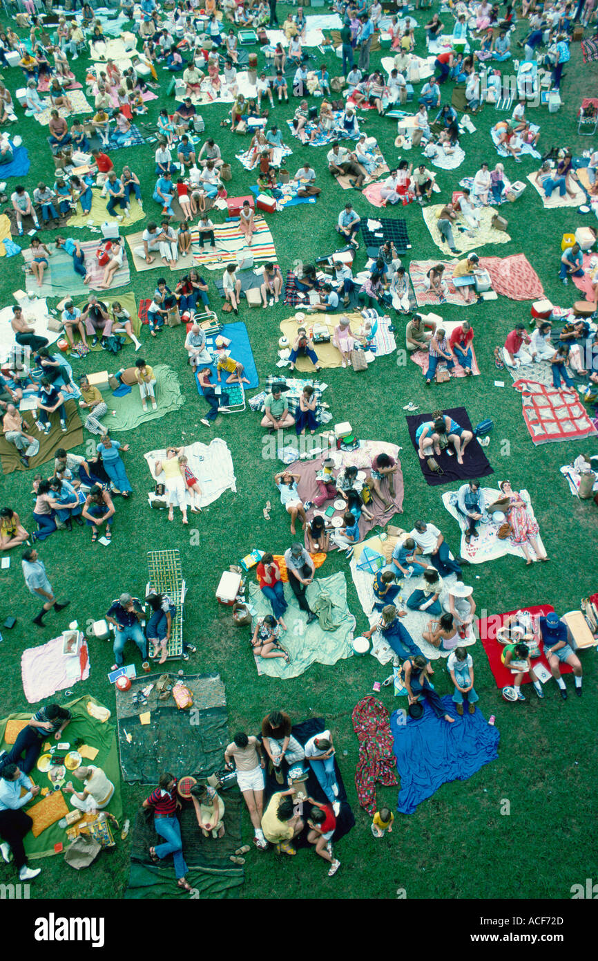 July 4th crowd on lie on lawn chairs and blankets on the grass at Wolf Trap Farm Park VA for a