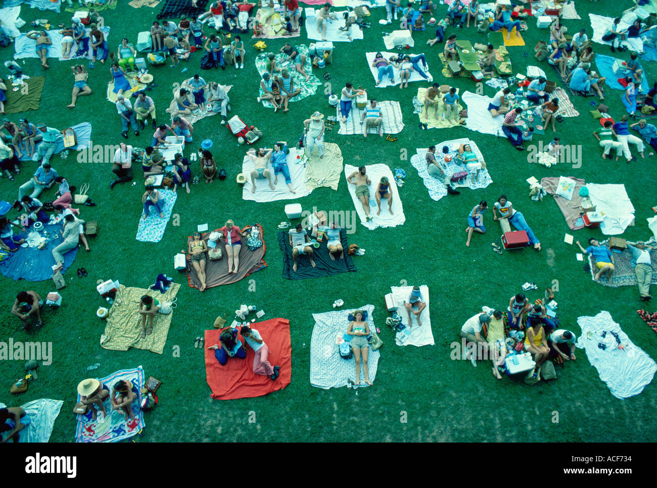 July 4th crowd on lie on lawn chairs and blankets on the grass at Wolf Trap Farm Park VA for a