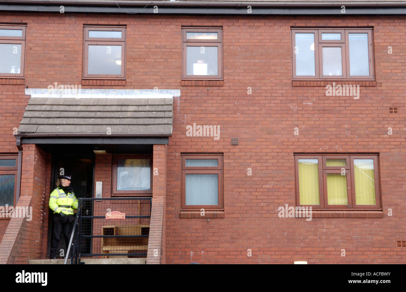 Police officers guard suspects house after murder of Father Paul Bennett stabbed to death in the grounds of his church Wales UK Stock Photo