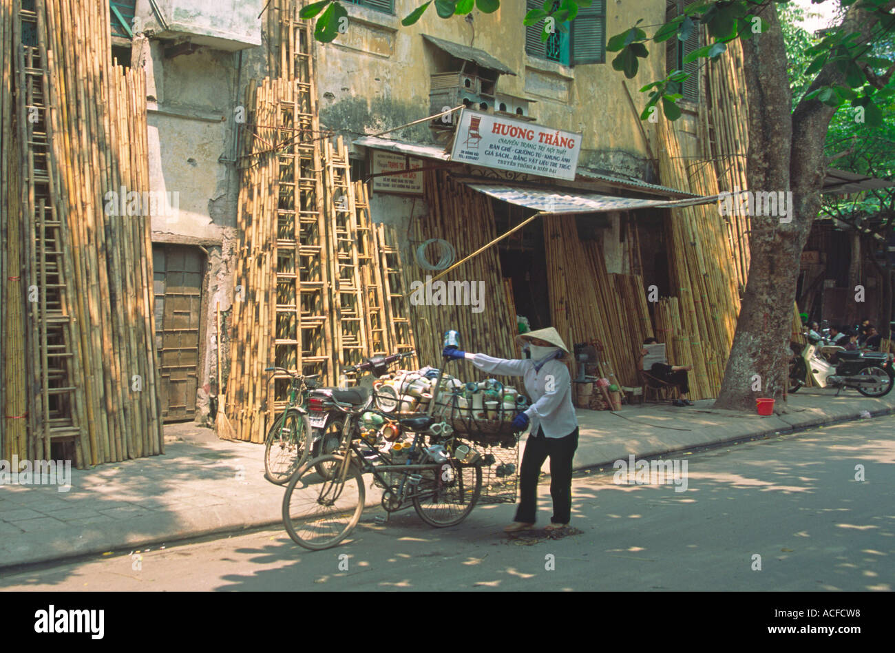 VMN Vietnam Hanoi street scene bamboo shop woman with bicycle Stock Photo