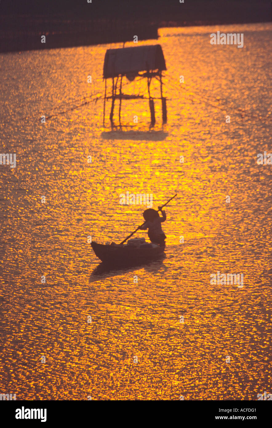 VNM Vietnam Nha Thrang river delta at sunset woman on a fisherboat Stock Photo