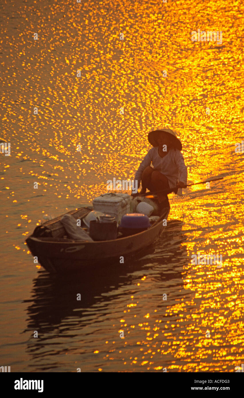 VNM Vietnam Nha Thrang river delta at sunset woman on a fisherboat Stock Photo