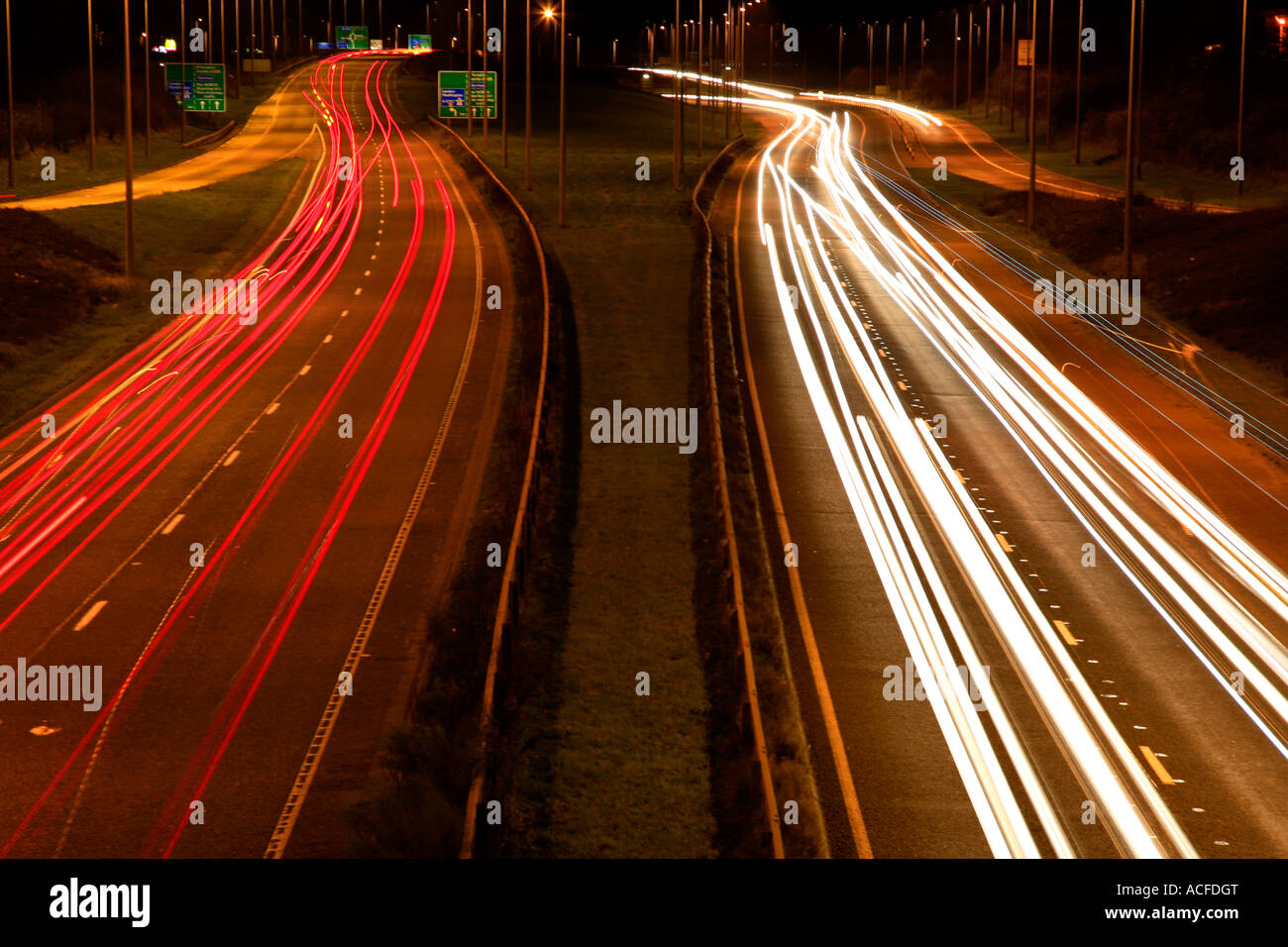 Speeding light trails from traffic on a busy road at night, generic roads, motorway Stock Photo