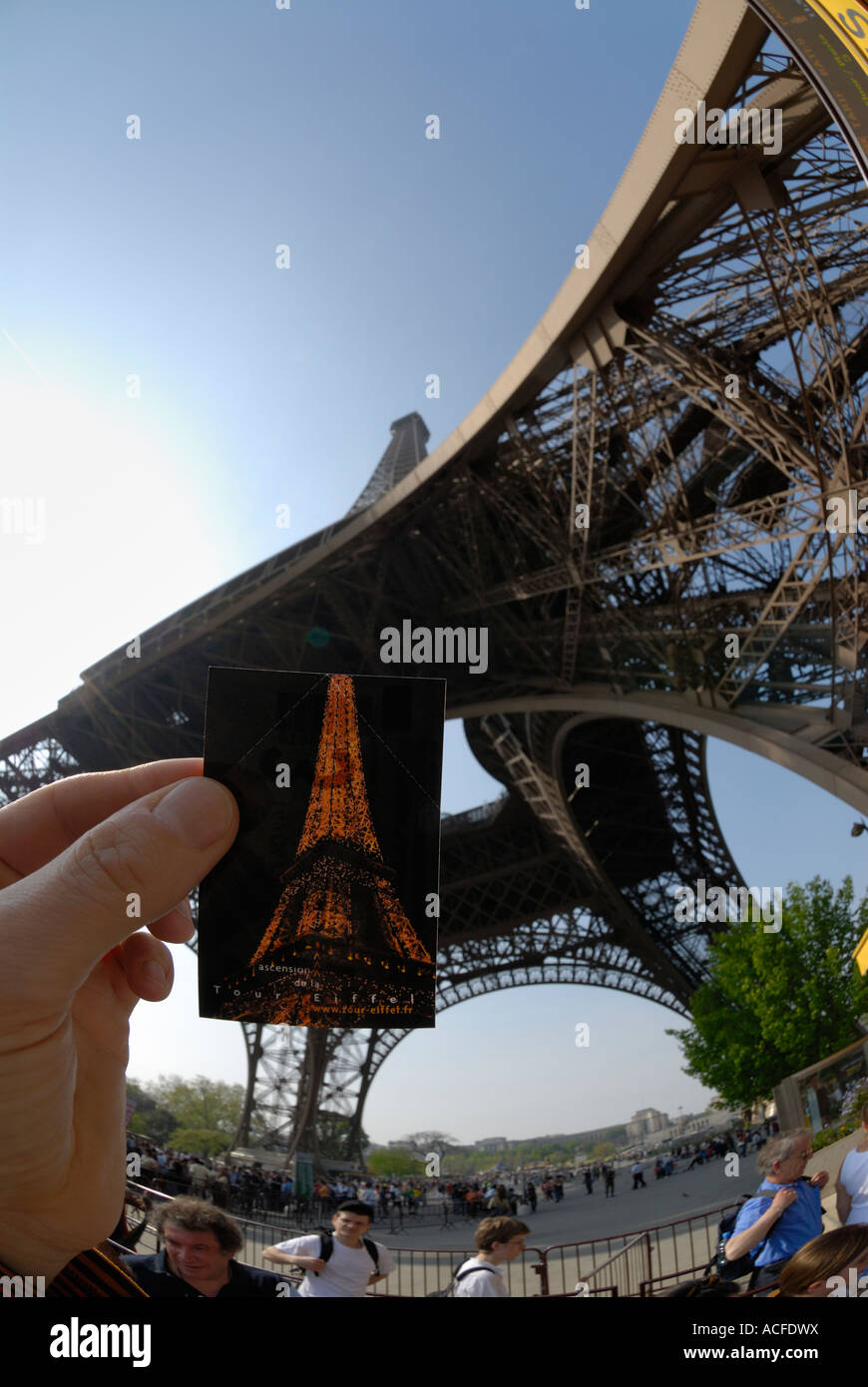 hand holding entrance ticket at the bottom of the eiffel tower in paris, france. Stock Photo