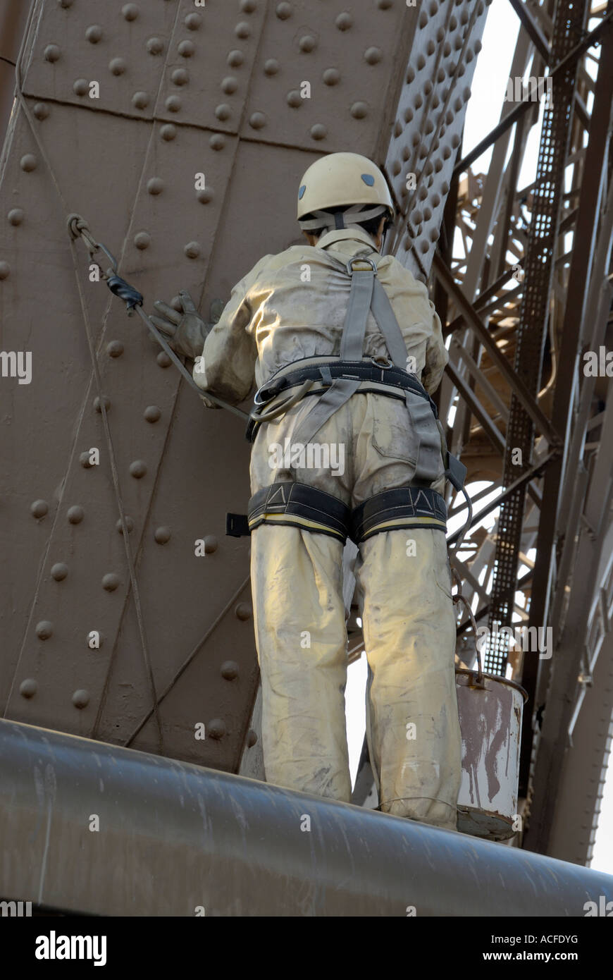 Painter (dummy) painting the steel elements at the Eiffel tower in Paris, France. Stock Photo