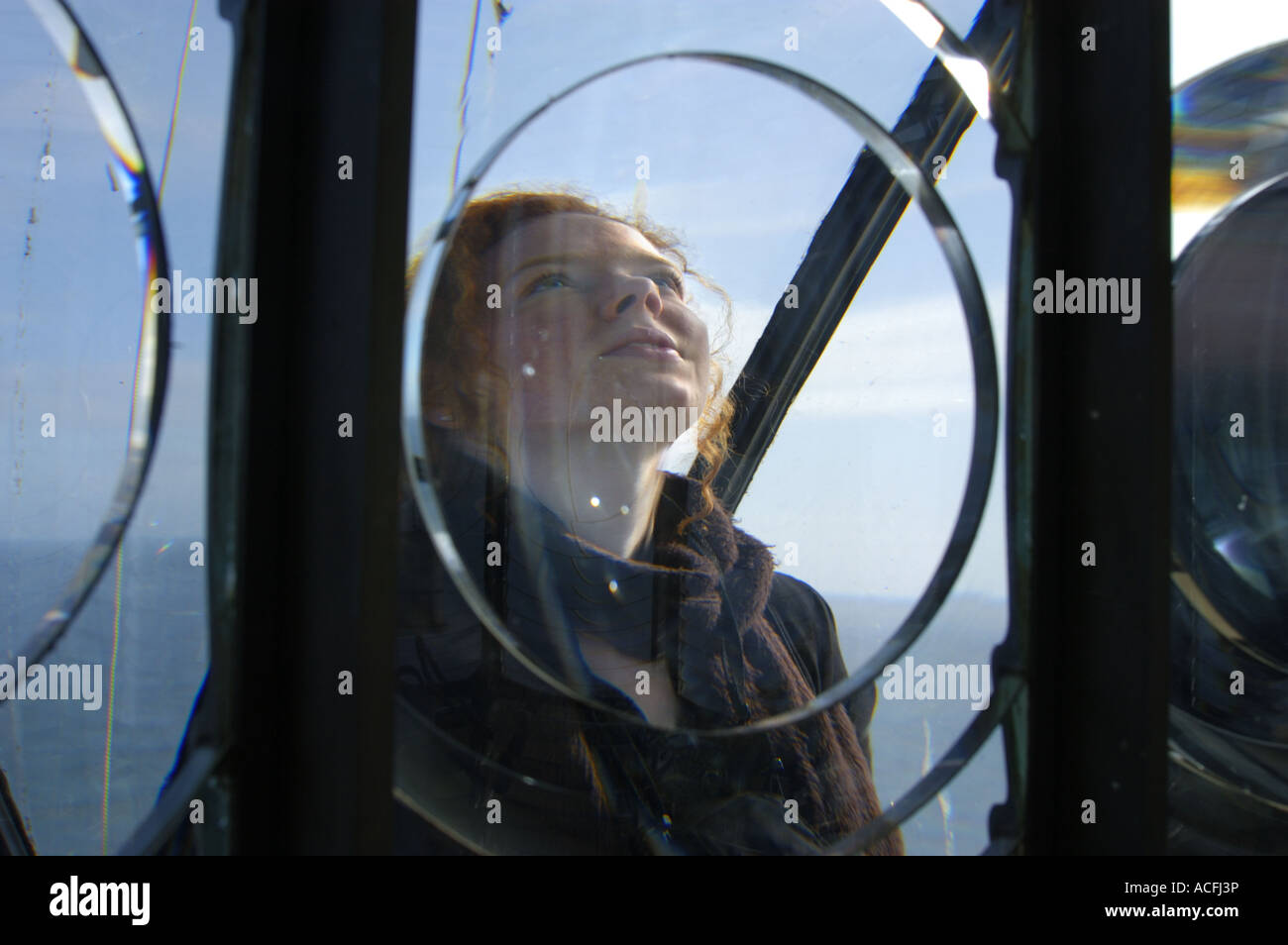A woman views the lens and lights of the New Lighthouse circa 1854 of North Ronaldsay Island Orkney Scotland Stock Photo