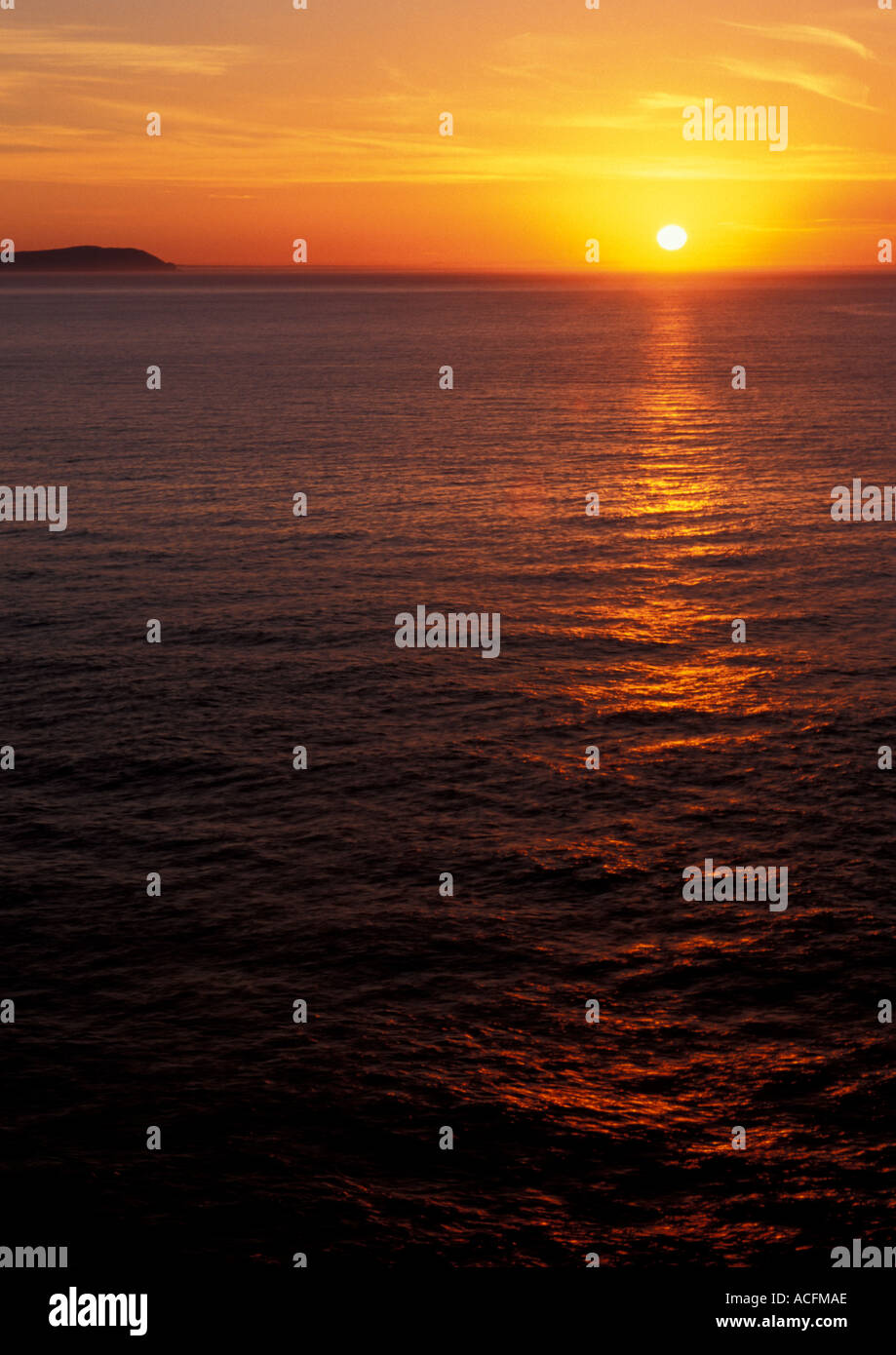 Orange sun rising over a southern Australia sea with an island ...