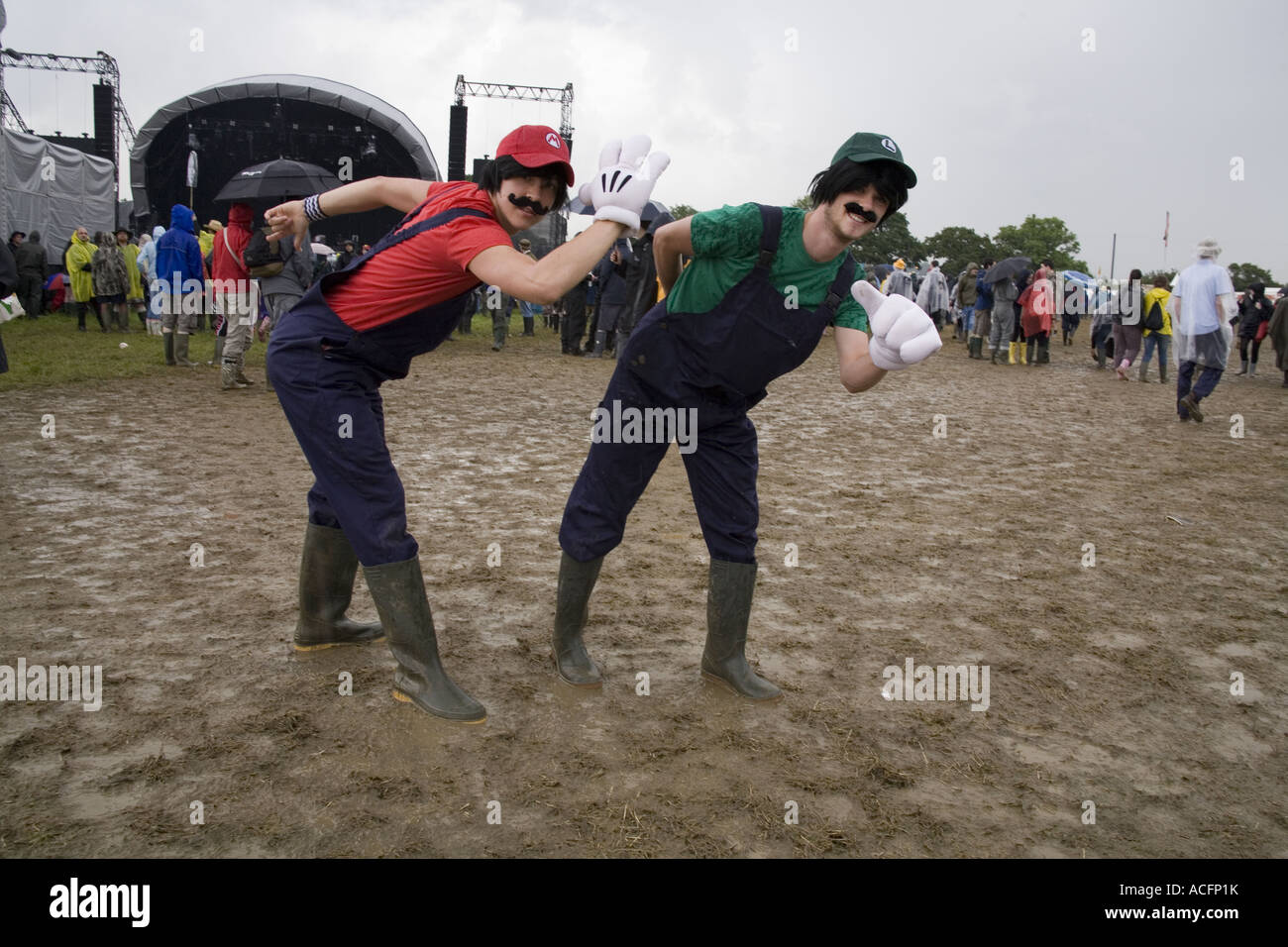 Two happy guys dressed in super mario brothers fancy dress at the Glastonbury festival 2007 Stock Photo