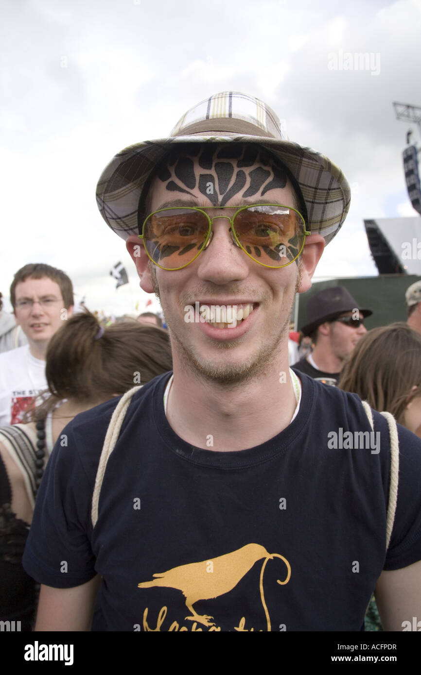 A man wearing glasses with facial tattoos at Glastonbury Festival 2007. Stock Photo