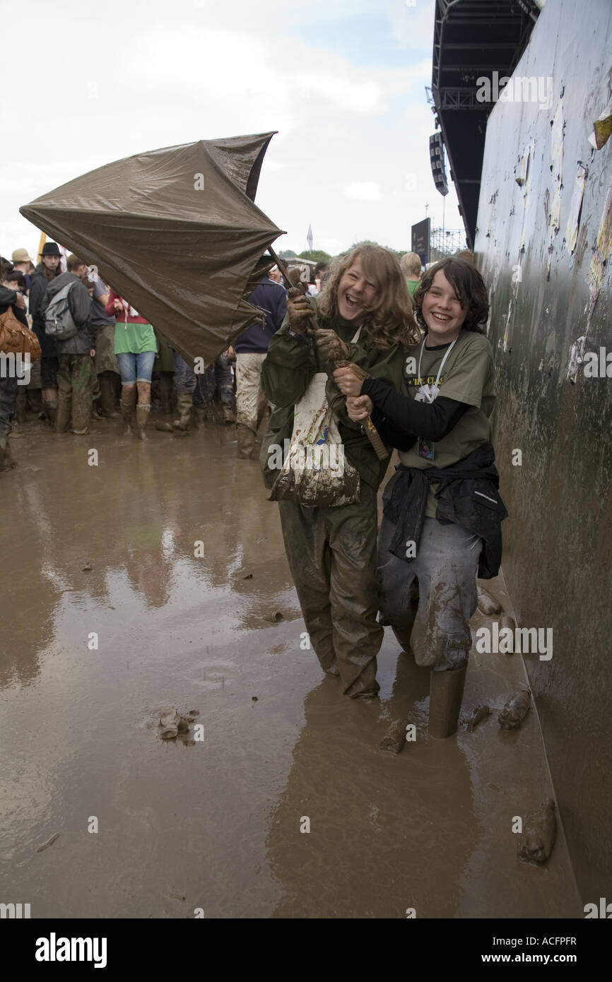 Two boys with a muddy umbrella at the Glastonbury Festival 2007 Stock Photo