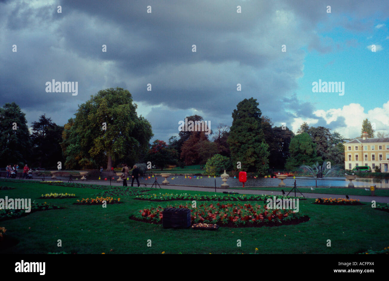 Kew Gardens with lake and flower bed, Surrey, England UK Stock Photo