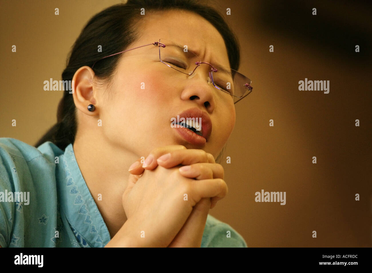 Woman praying Stock Photo