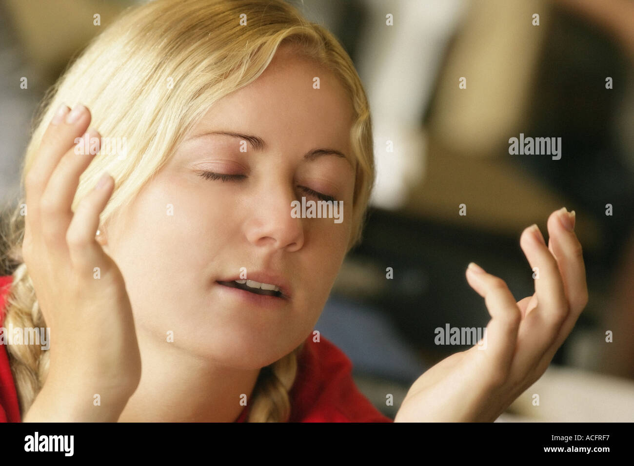 Woman with hands raised Stock Photo