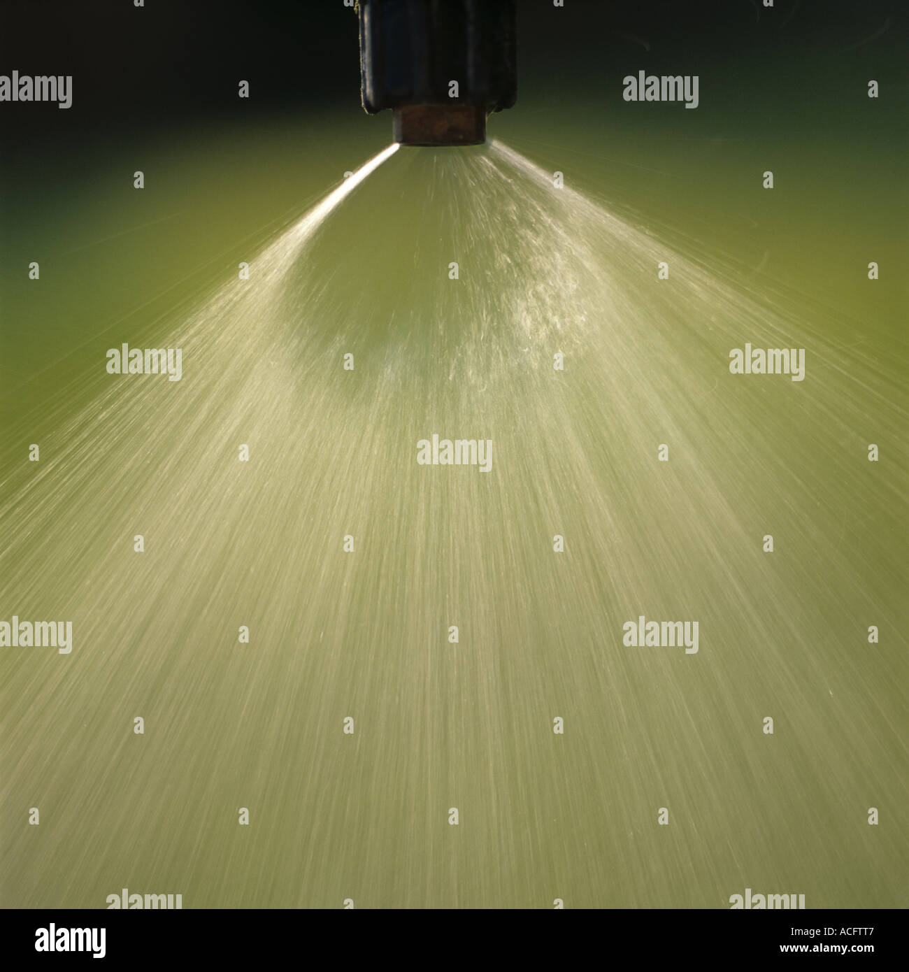 Spray from a 110 degree 02 Teejet nozzle used for crop field spraying Stock Photo