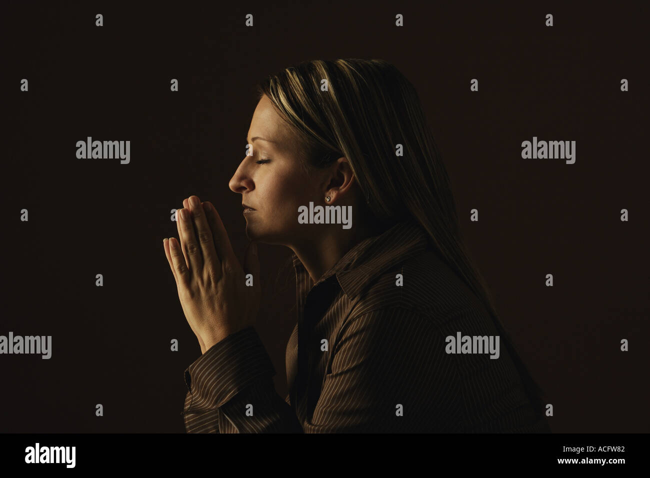 Woman praying Stock Photo