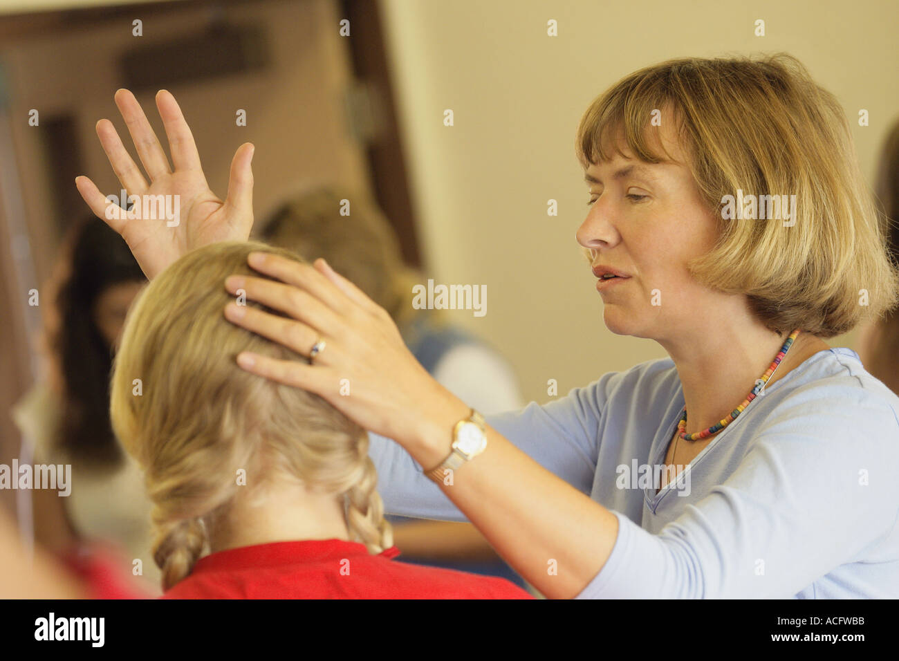 Woman praying for teen Stock Photo