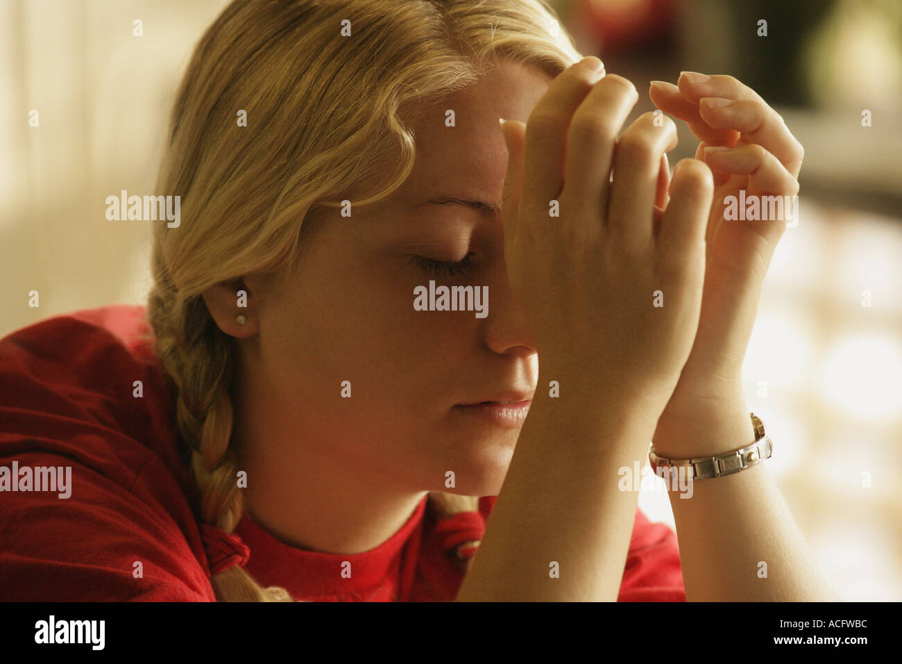 Teenager praying Stock Photo