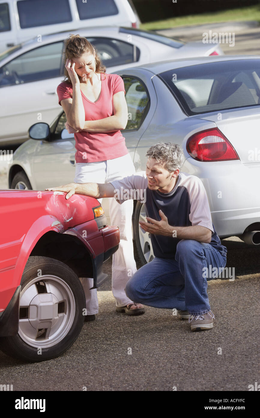 Couple return to find their car damaged Stock Photo