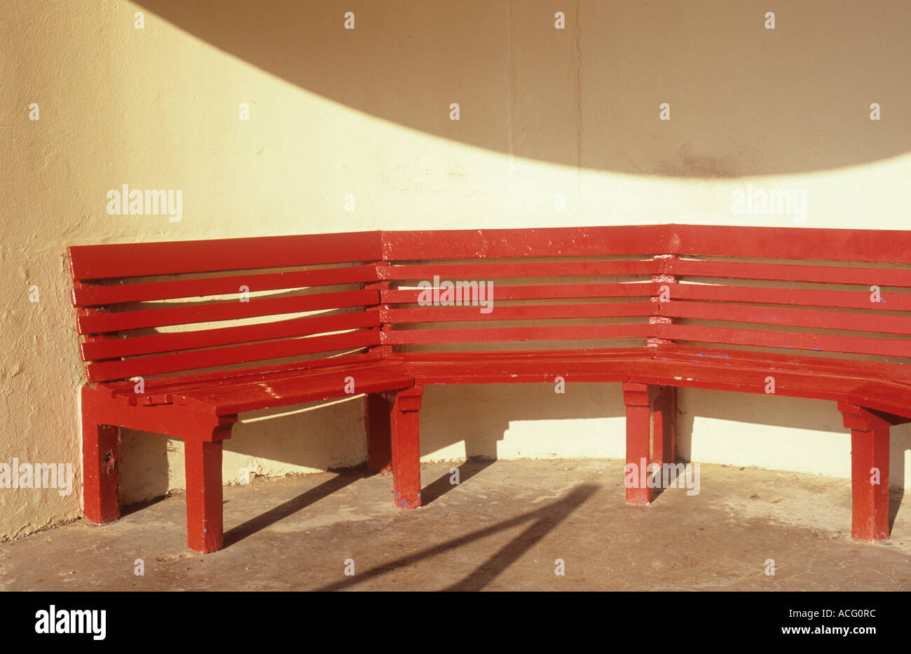 Detail Of A Red Bench Seat In A Modernistic Circular Cream Shelter