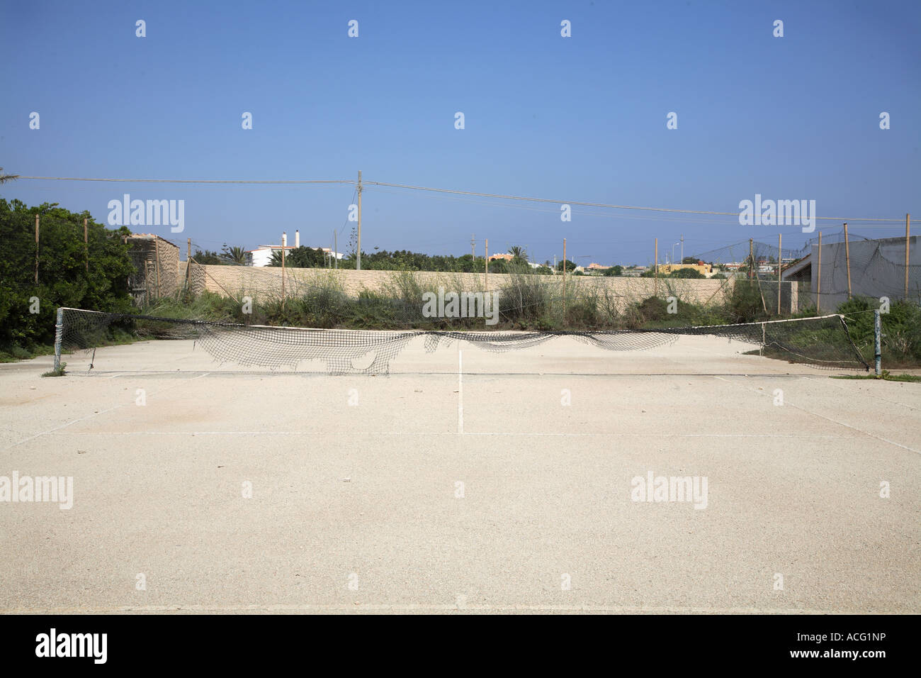 Empty and ruined tennis court Stock Photo